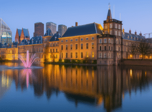 The Hague – illuminated Binnenhof buildings reflecting on Hofvijver lake during blue hour